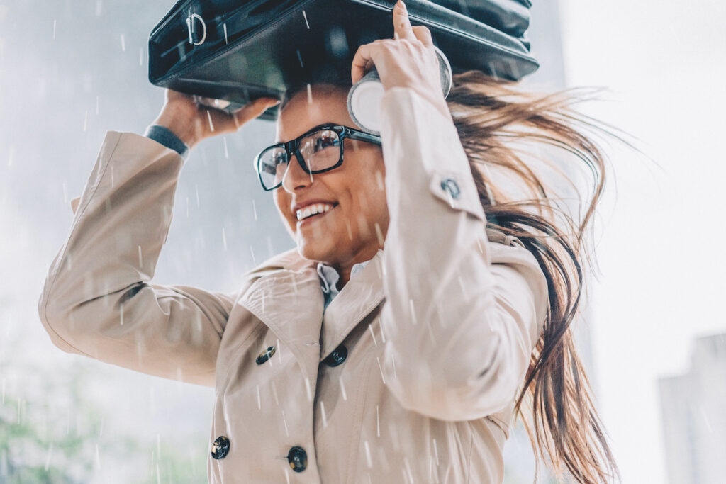 Woman happily sheltering from the rain