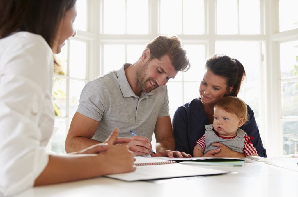 Woman signing insurance to keep family safe